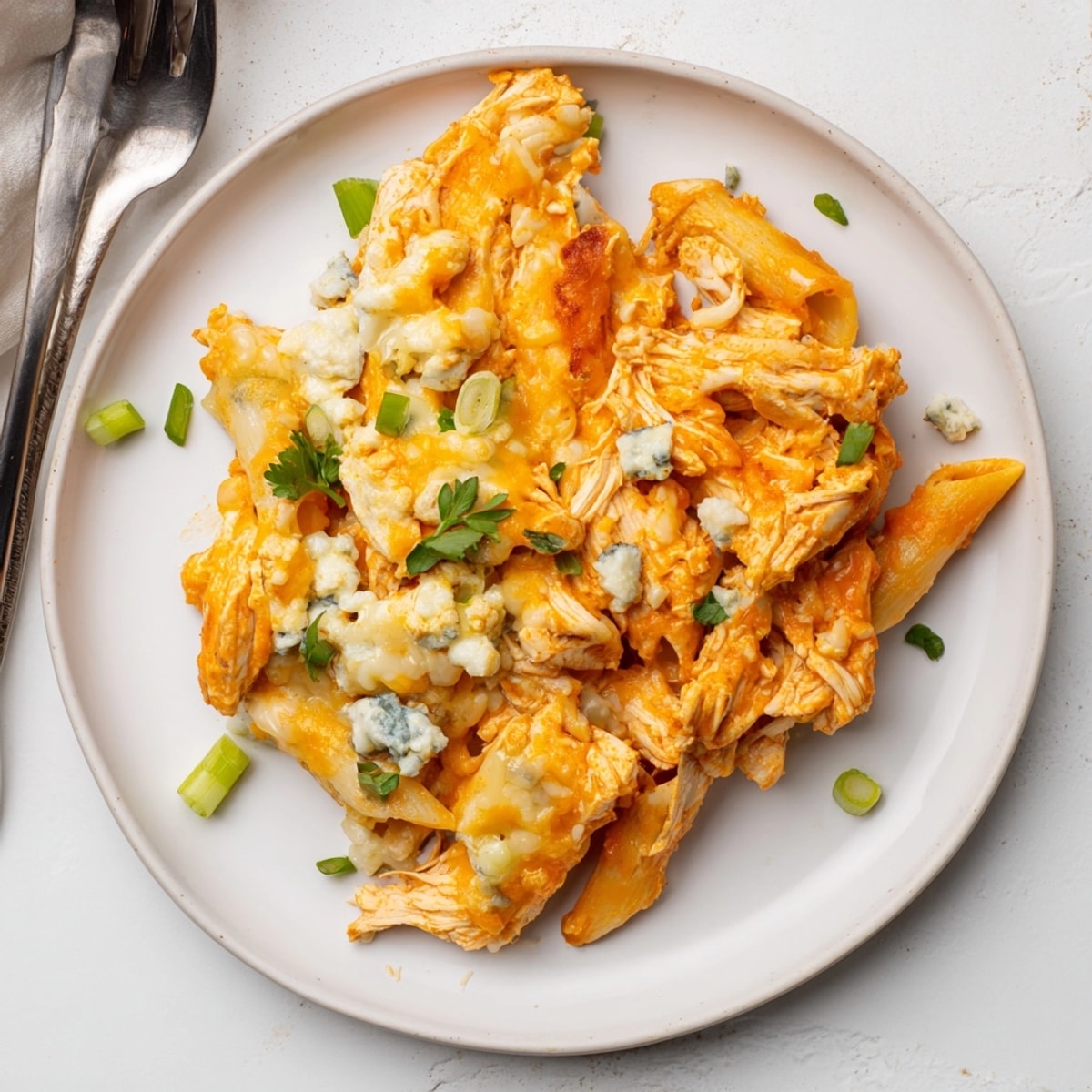 Golden, bubbly Buffalo Chicken Pasta Bake, hot from the oven with cheesy topping.