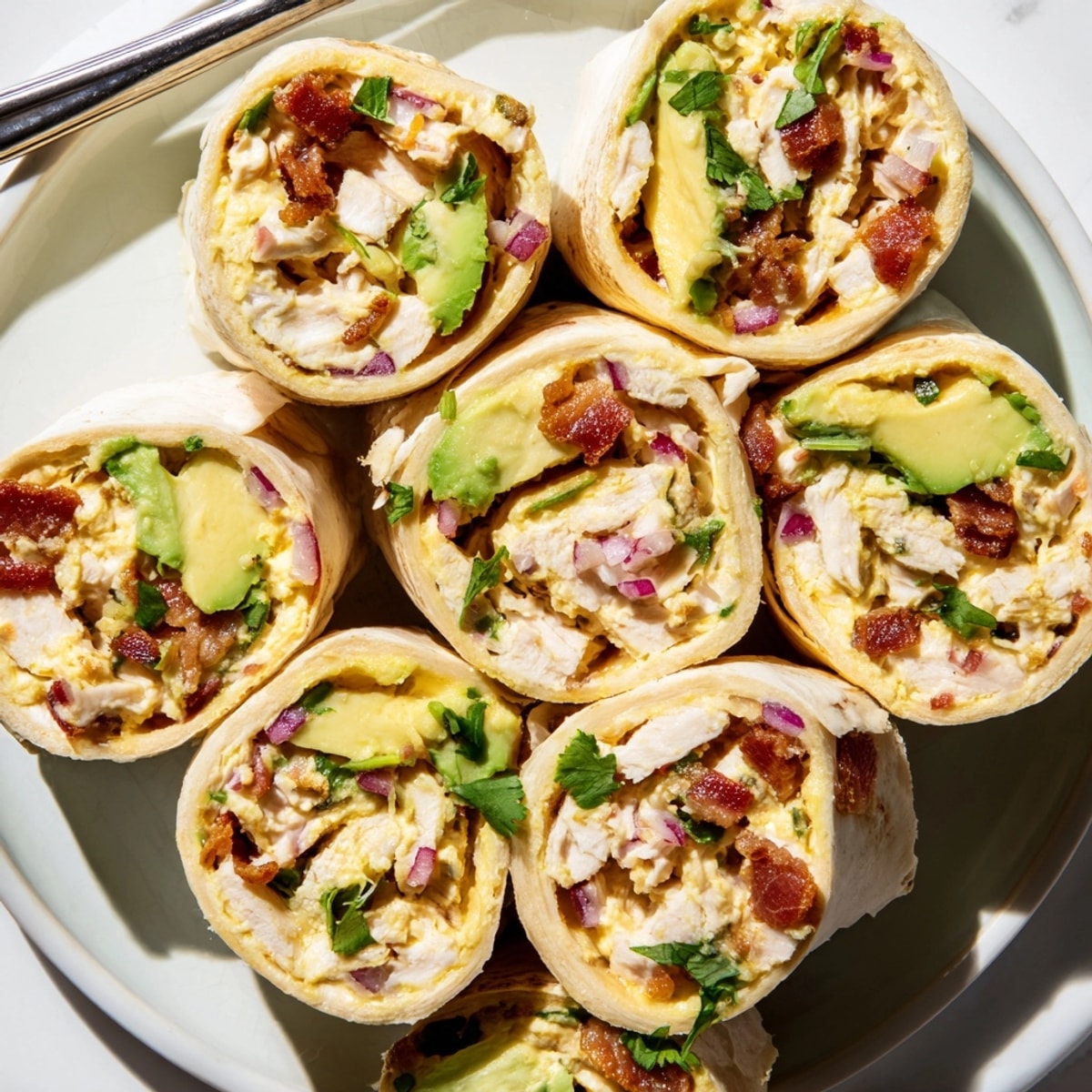 Looking for a simple recipe? Try sliced Avocado Chicken Bacon Pinwheels with zesty filling.