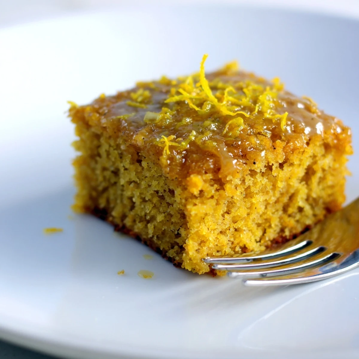 Moist lemon ginger pumpkin cake squares drizzled with tangy lemon glaze for fall.  