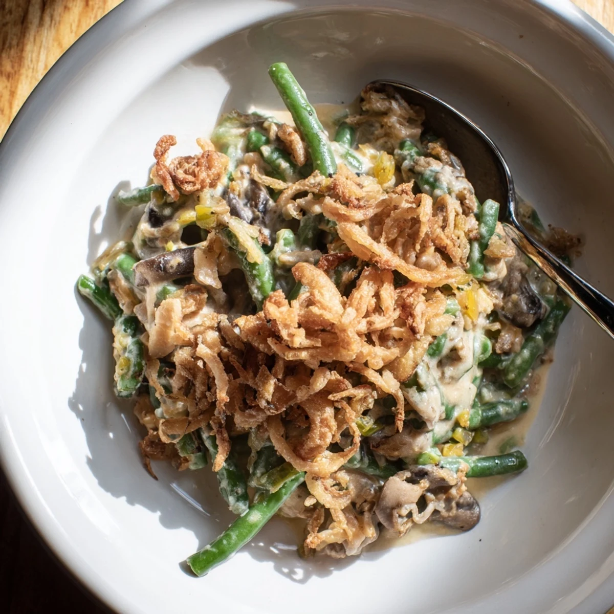 Creamy Old-School Green Bean Casserole topped with crispy onions, perfect for holiday gatherings.