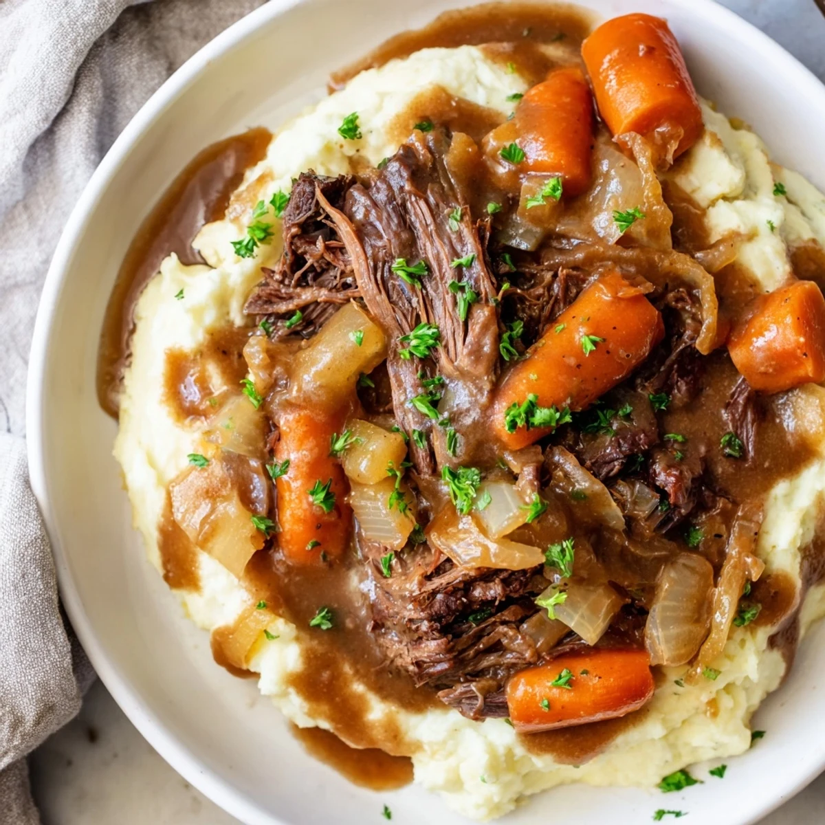 Shredded slow cooker pot roast with tender vegetables and creamy mashed potatoes looks divine.
