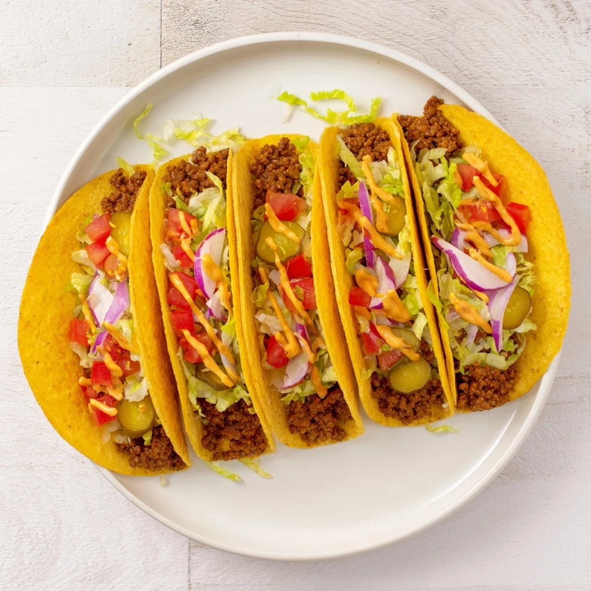 Golden-brown Viral Cheeseburger Tacos overflowing with juicy, seasoned beef, melted cheese, and fresh toppings.