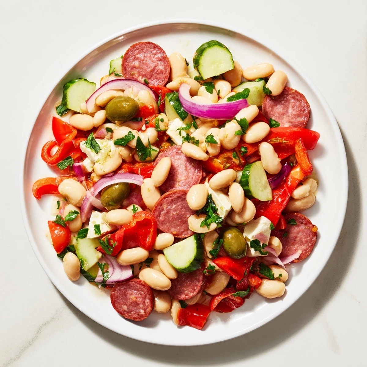Freshly tossed Italian Antipasto Bean Salad with vibrant red tomatoes and creamy cannellini beans.