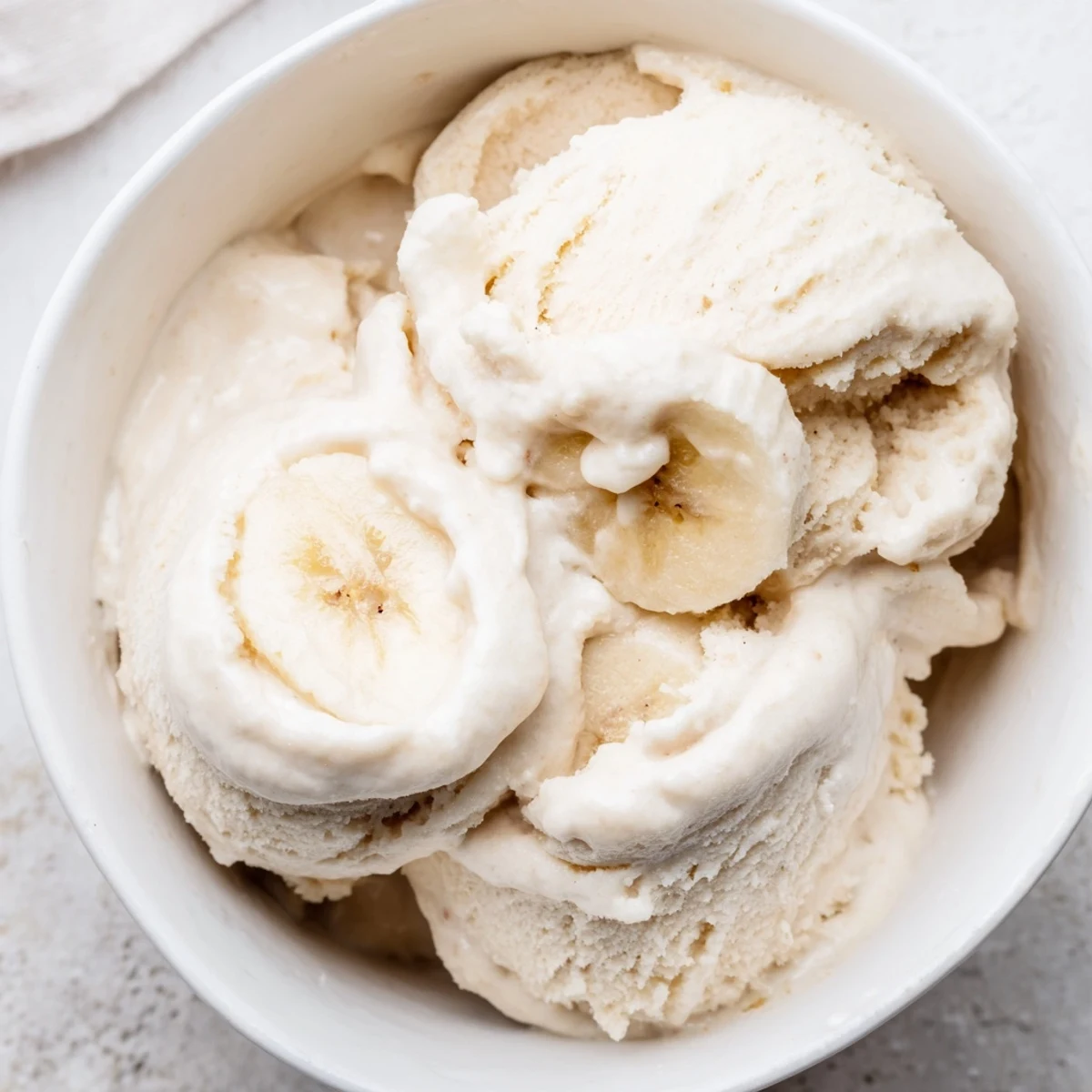 A refreshing bowl of 2-Ingredient Banana Ice Cream, perfectly smooth and creamy after blending.