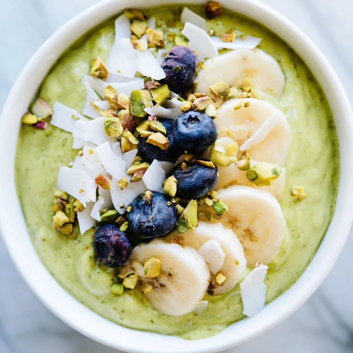 Creamy matcha overnight oats topped with fresh berries, a delightful, healthy breakfast option.