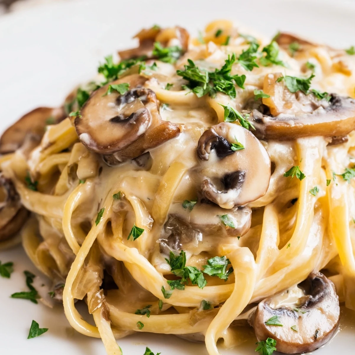 Close-up view of Creamy Mushroom Alfredo, highlighting the rich, creamy sauce coating the al dente pasta.