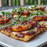 Sweet grilled peaches and melted Brie atop crispy flatbread, perfect for summer BBQs.  