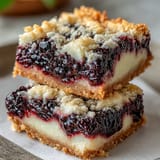Bright, tangy Blackberry Lemon Bars with buttery shortbread, ready to enjoy.