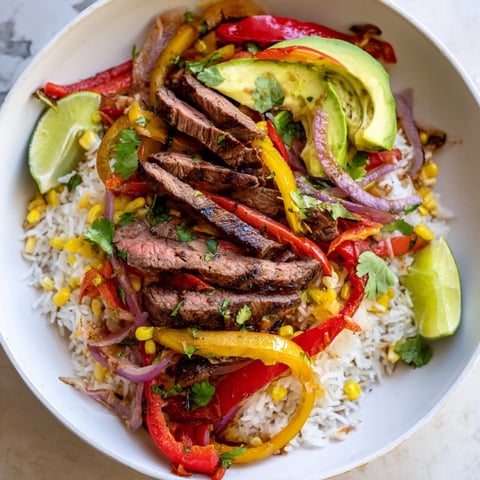 Smoky BBQ Steak Fajita Bowls with colorful peppers and cilantro, ready to eat.