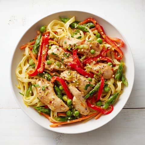 Steaming Lemon-Garlic Chicken Stir Fry with Noodles, a flavorful dish with colorful vegetables and savory sauce.