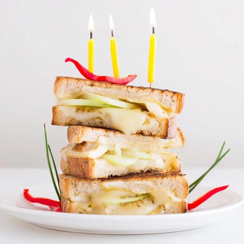 Golden-brown Brie, Apple & Honey Christmas Candle Grilled Cheese, oozing melted cheese and tempting flavors.