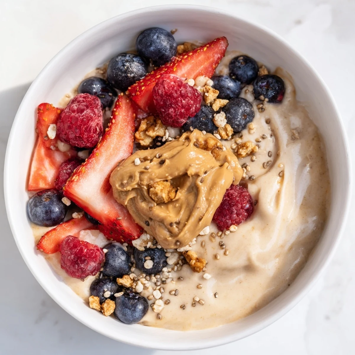 Frozen Protein Ice Cream Bowls with fresh berries and granola, a healthy dessert option.