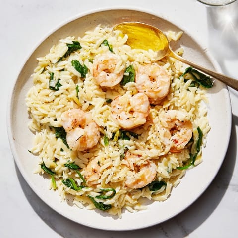 Close-up of creamy lemon orzo with shrimp highlighting the tender pasta and plump shrimp.