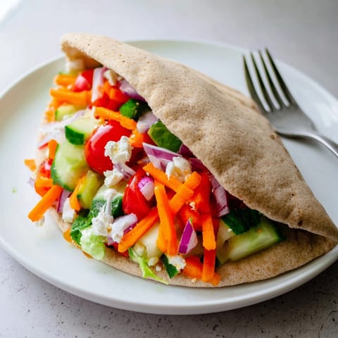 Close-up shows fluffy pita, stuffed with a cool, herby Garlic Ranch Veggie Pocket.