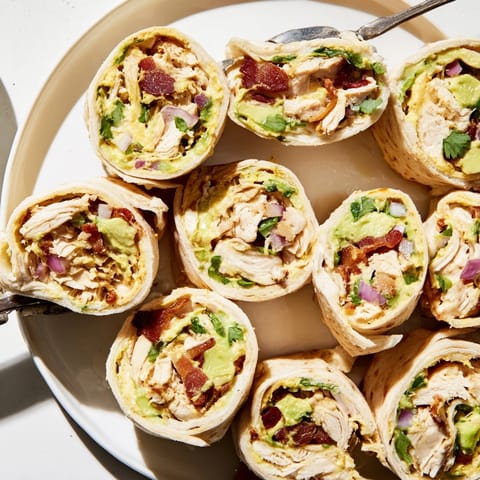 Close-up of colorful Avocado Chicken Bacon Pinwheels, a tasty, easy appetizer for gatherings.