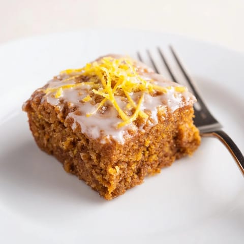 Aromatic pumpkin cake squares with ginger, lemon zest, perfect for cozy gatherings.  