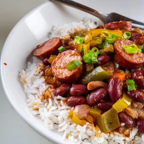 A comforting bowl of red beans & rice with smoky sausage and vibrant veggies.  