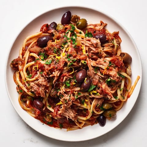 This Pasta with Tuna, Olives & Capers recipe shows a close-up of the finished, flavorful dish served.