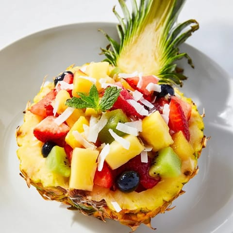Brightly colored Tropical Bliss Pineapple Fruit Boat, a delicious and easy vegan dessert, ready to serve and enjoy.