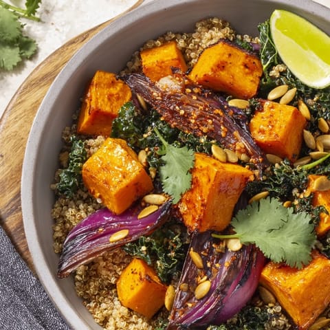 Roasted Sweet and Spicy Red Kuri Squash Bowl garnished with fresh cilantro and lime wedges.  