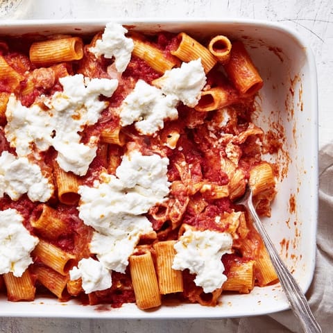 Freshly baked Freezer Make-Ahead Baked Ziti served steaming hot, paired with a crisp green salad for dinner.
