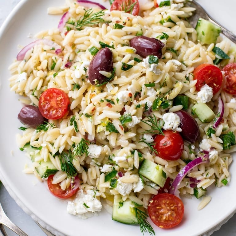 Close-up of tangy Greek Orzo with Feta and Olives; a flavorful Mediterranean main dish.