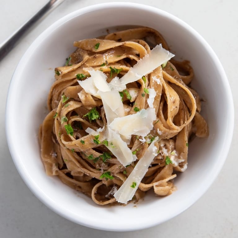 Bowl of creamy Garlic Browned Butter Noodle Bowls with parmesan and fresh parsley.