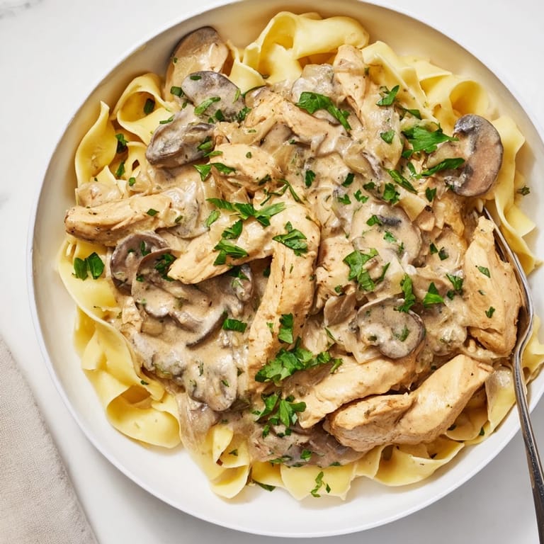 Delicious bowl of Creamy Chicken Stroganoff featuring garlic, mushrooms, and hearty chicken.