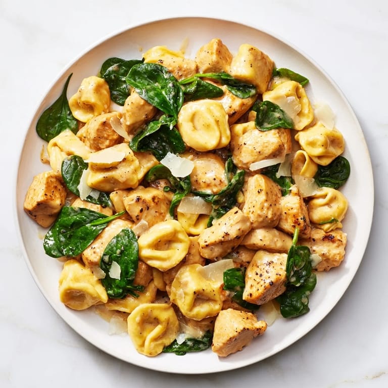 Savor the delicious Creamy Chicken and Spinach Tortellini, creamy sauce perfectly coating each tender bite.