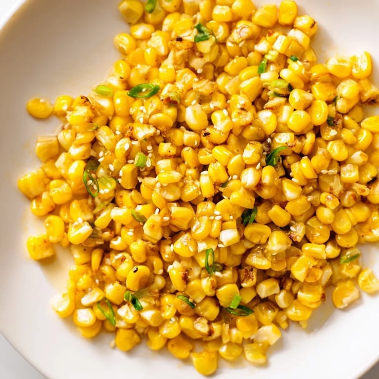 Steaming bowl of flavorful Japanese Butter Corn sprinkled with sesame seeds, perfect for any meal.