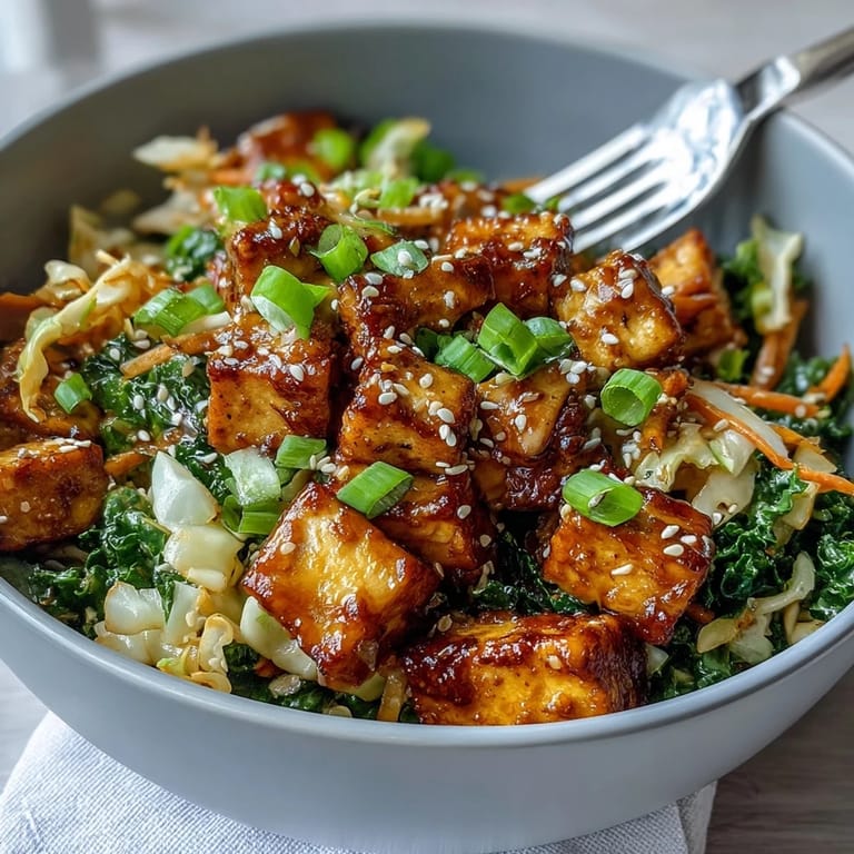 A close-up of the Tofu Egg Roll in a Bowl, garnished with sesame seeds and fresh green onions, served in a ceramic bowl.