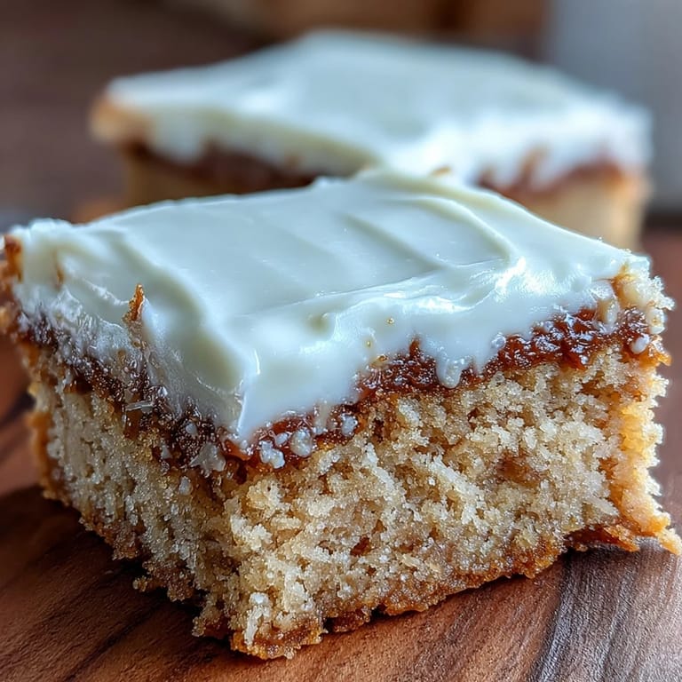 Perfectly sliced Almond Flour Sugar Cookie Bars reveal a soft crumb, topped with creamy frosting and optional sprinkles.