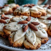 Delicate flower-shaped shortbread cookies with vibrant royal icing, perfect for a cheerful spring celebration.